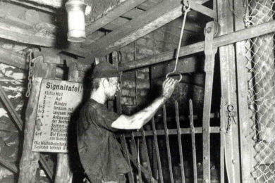 Bergmann im Bergwerk betätigt die Signalanlage