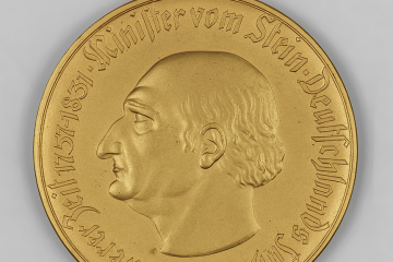 Goldene Münze mit einem Mann im Profil, die Umschrift lautet: ‚Minister vom Stein. Deutschlands Fuehrer in schwerer Zeit 1757–1831‘.